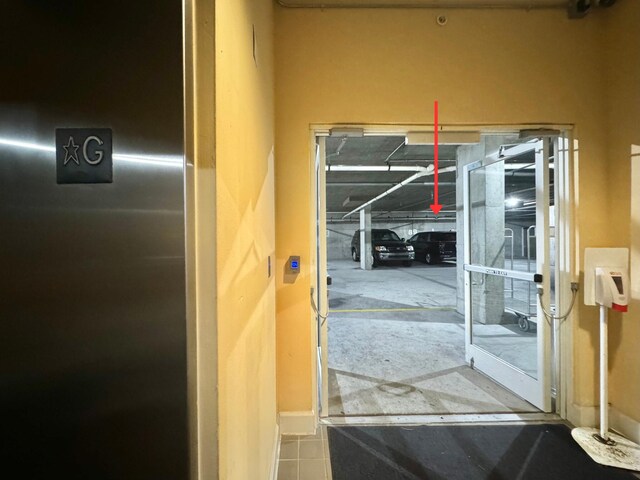 doorway to outside featuring elevator and tile patterned floors