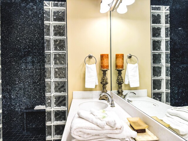 bathroom featuring a shower and vanity