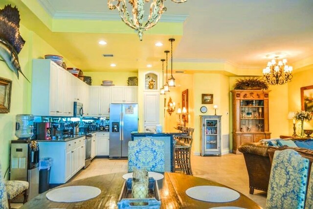 kitchen featuring crown molding, an inviting chandelier, white cabinets, and stainless steel refrigerator with ice dispenser