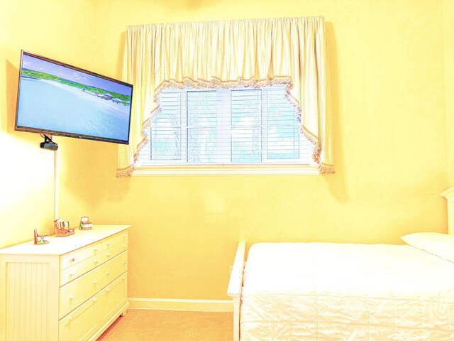 bedroom featuring light tile patterned flooring