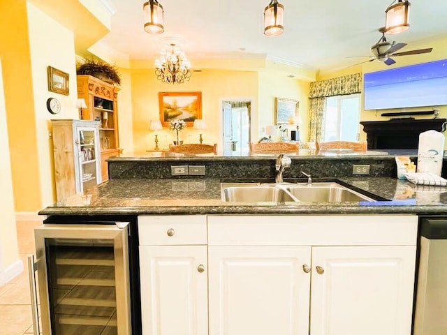 kitchen featuring dishwasher, white cabinetry, beverage cooler, and sink