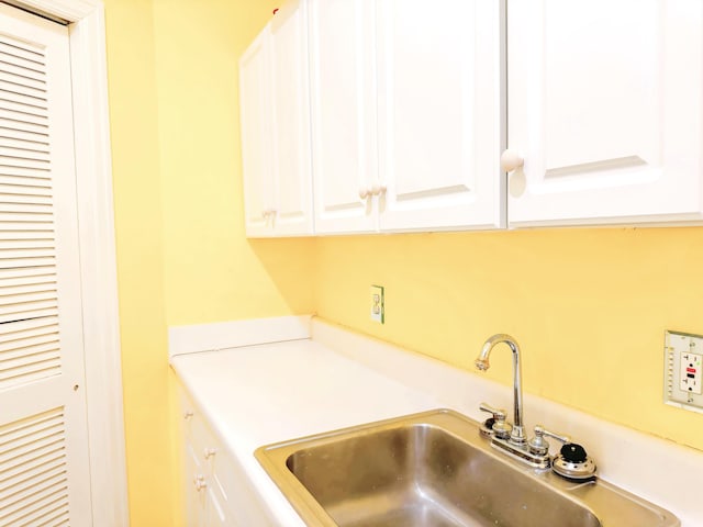 clothes washing area featuring a sink