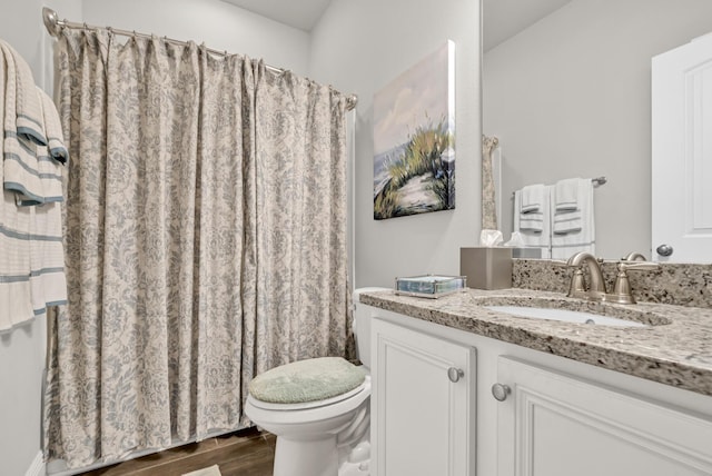 bathroom featuring vanity and toilet