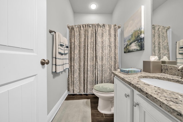 bathroom with walk in shower, vanity, and toilet