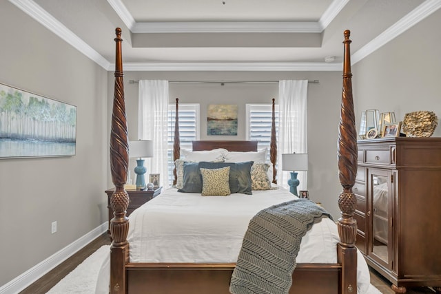 bedroom featuring hardwood / wood-style floors, a raised ceiling, and crown molding