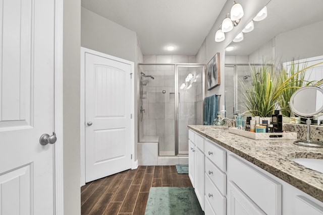 bathroom with vanity and a shower with door