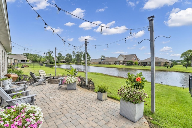 view of patio / terrace featuring a water view and a fire pit