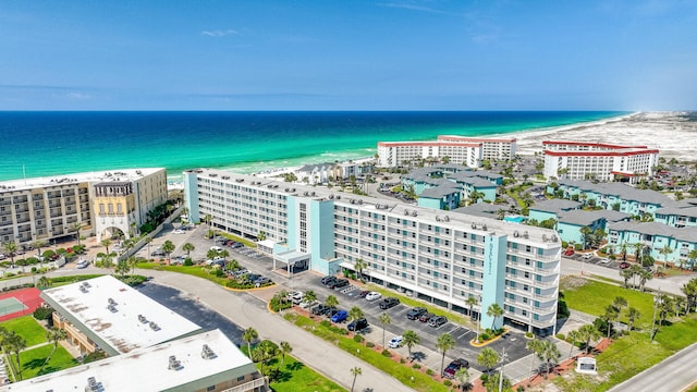 birds eye view of property featuring a beach view and a water view