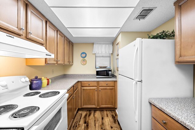 kitchen featuring white appliances and dark wood-type flooring