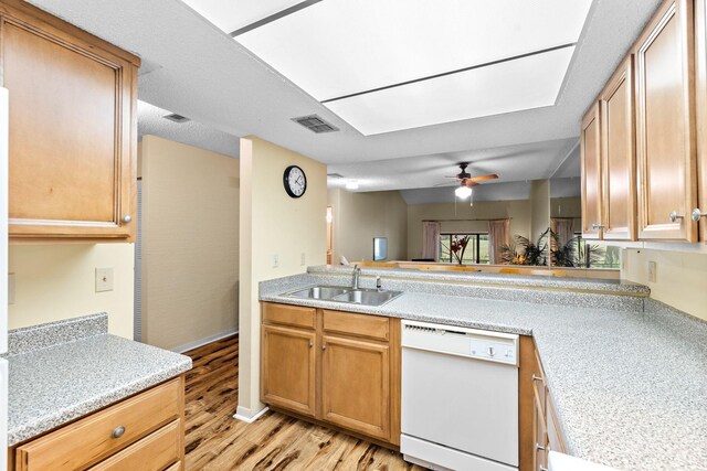 kitchen with white dishwasher, ceiling fan, sink, and light hardwood / wood-style flooring