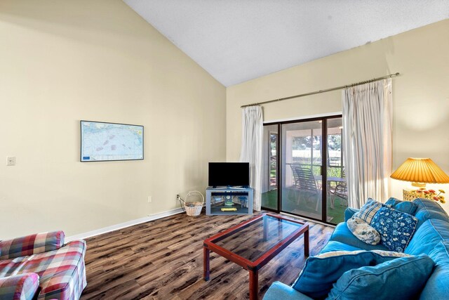 living room featuring hardwood / wood-style flooring and vaulted ceiling