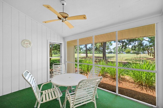 sunroom with a healthy amount of sunlight, ceiling fan, and lofted ceiling