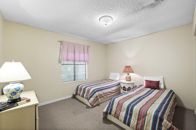 carpeted bedroom with a textured ceiling