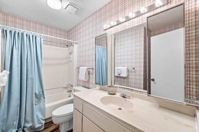 full bathroom with shower / bathtub combination with curtain, a textured ceiling, toilet, vanity, and hardwood / wood-style flooring