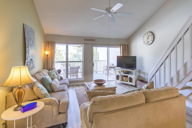 living room featuring wood-type flooring, high vaulted ceiling, and ceiling fan