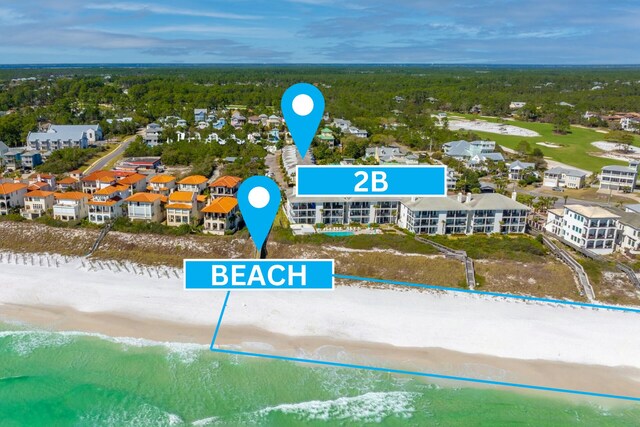 bird's eye view featuring a water view and a beach view