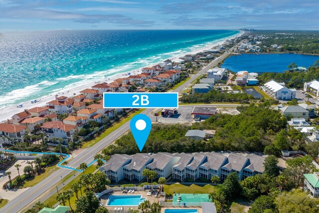 aerial view featuring a water view and a beach view