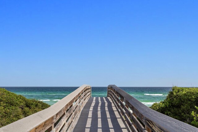 surrounding community featuring a water view and a view of the beach