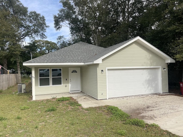 ranch-style home with a front lawn, a garage, and central AC unit