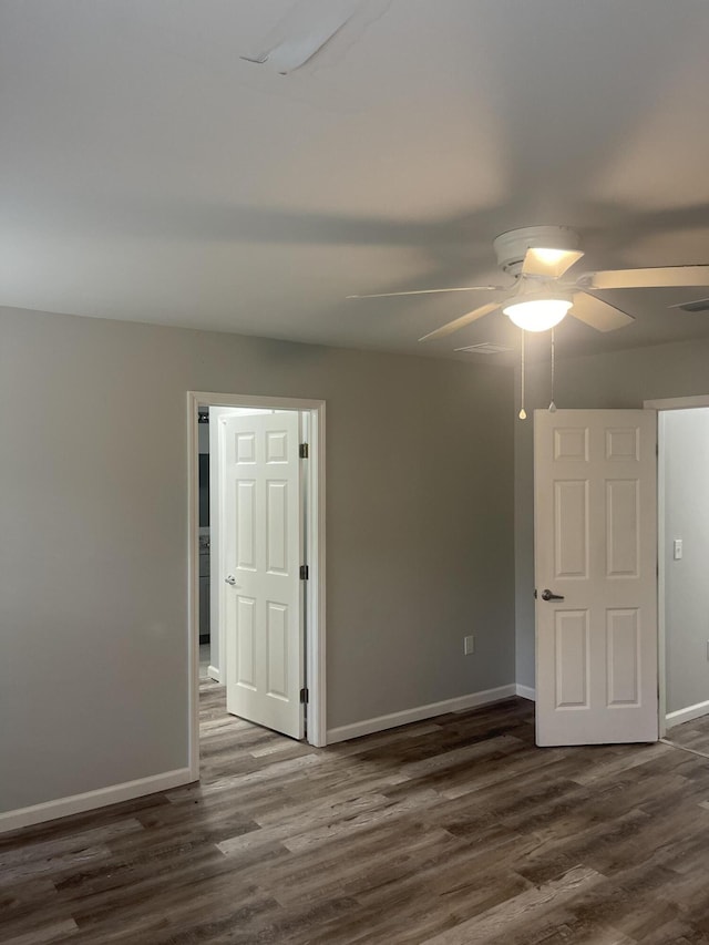 empty room featuring ceiling fan and dark hardwood / wood-style flooring