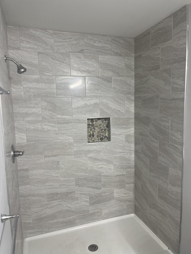 bathroom with tiled shower