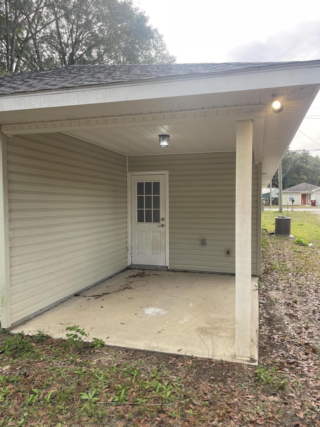 entrance to property with cooling unit and a patio