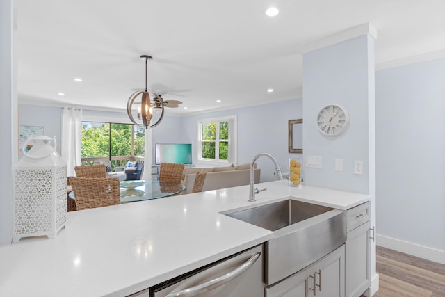 kitchen featuring ceiling fan, light hardwood / wood-style flooring, dishwasher, pendant lighting, and sink