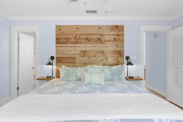 unfurnished bedroom featuring hardwood / wood-style flooring and crown molding