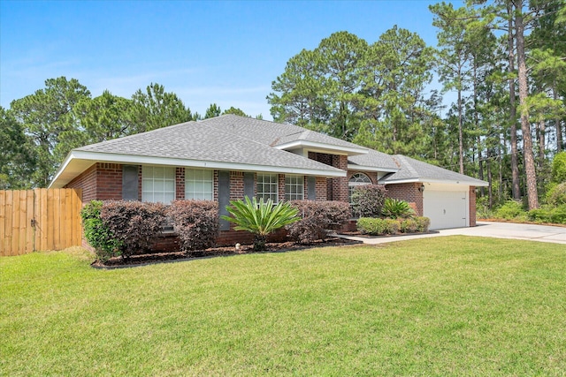 ranch-style home featuring a front yard and a garage