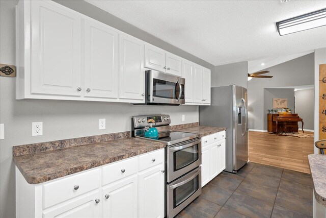 kitchen featuring white cabinets, stainless steel appliances, and ceiling fan