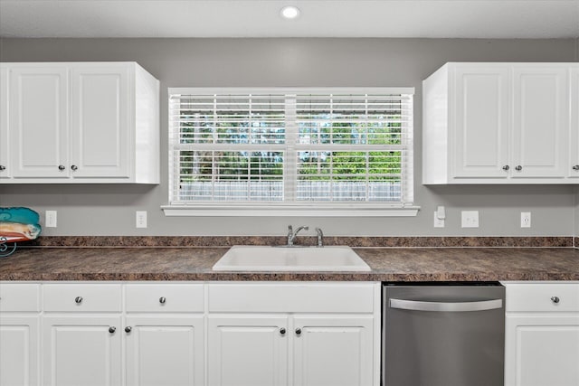 kitchen with dishwasher, white cabinetry, sink, and a wealth of natural light