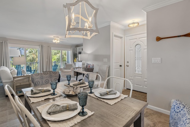 dining room with ceiling fan with notable chandelier and crown molding