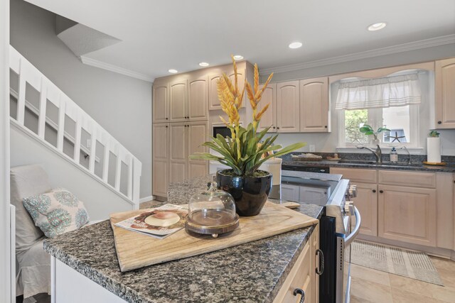 kitchen featuring light tile patterned floors, dark stone counters, crown molding, and sink