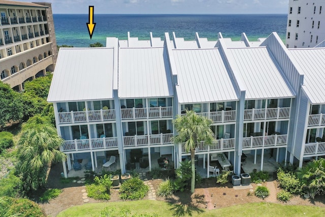 view of building exterior with a water view and cooling unit