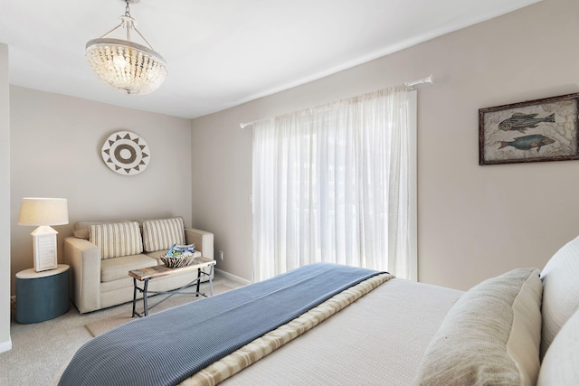 bedroom with a chandelier and light carpet