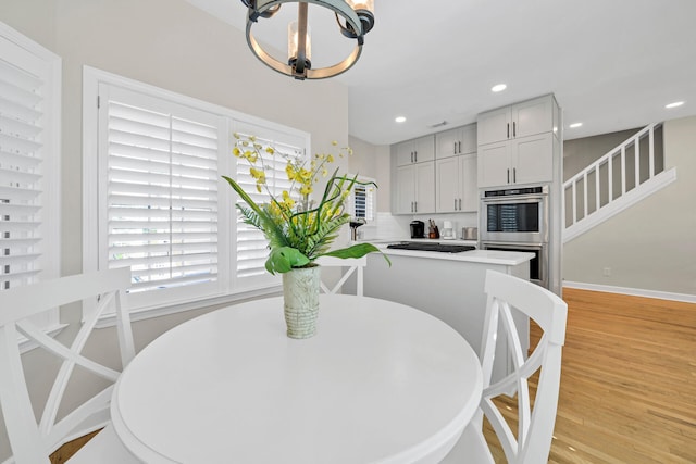 dining room with a notable chandelier and light hardwood / wood-style flooring