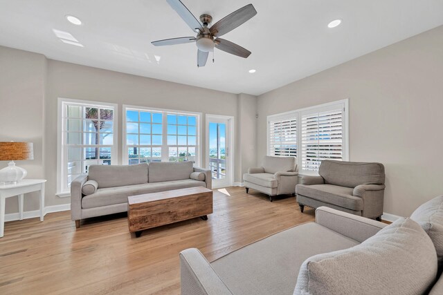 living room featuring ceiling fan and light hardwood / wood-style flooring