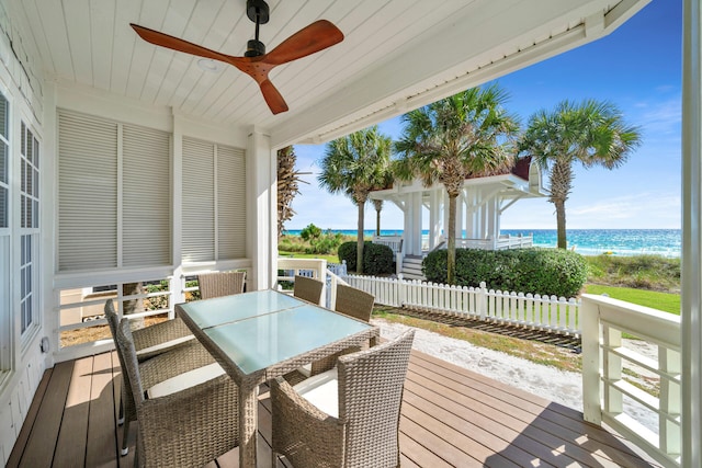 wooden deck featuring a water view and ceiling fan