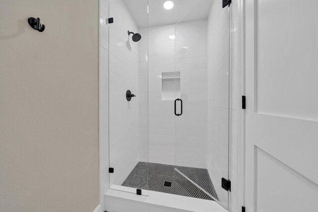 bathroom with a shower with shower door