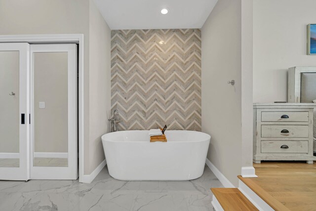 bathroom with tile floors and a washtub