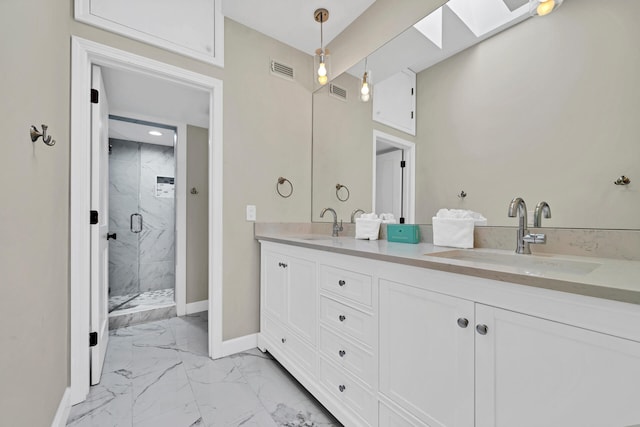 bathroom featuring tile flooring, oversized vanity, double sink, walk in shower, and a skylight