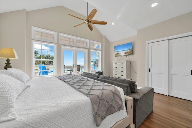 bedroom featuring french doors, access to outside, hardwood / wood-style floors, high vaulted ceiling, and ceiling fan