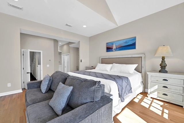 bedroom featuring vaulted ceiling and hardwood / wood-style flooring