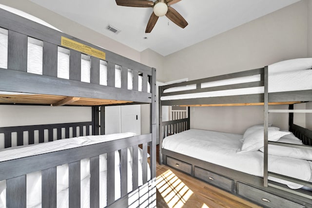 bedroom featuring light wood-type flooring, vaulted ceiling, and ceiling fan