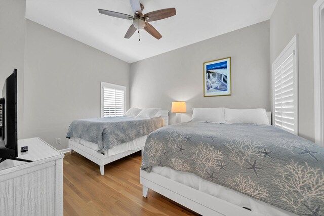 bedroom with wood-type flooring and ceiling fan