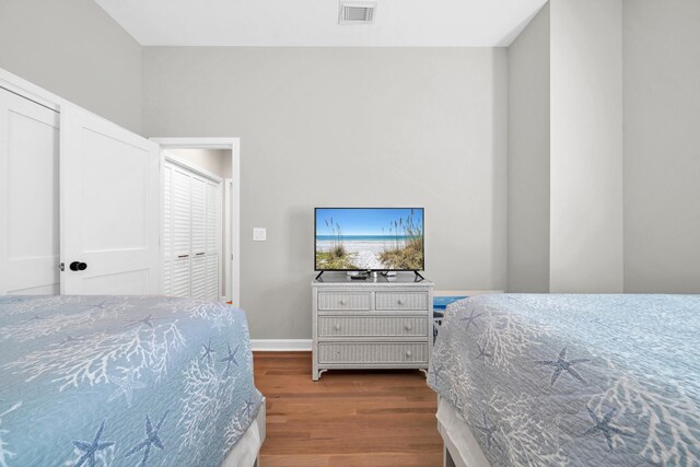 bedroom with a closet and hardwood / wood-style floors