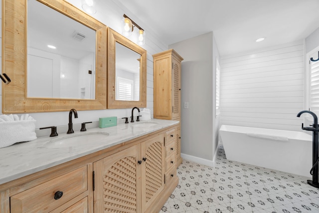 bathroom with tile floors, double sink vanity, and a bath to relax in