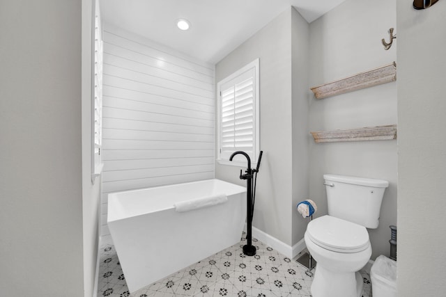 bathroom featuring tile flooring and toilet