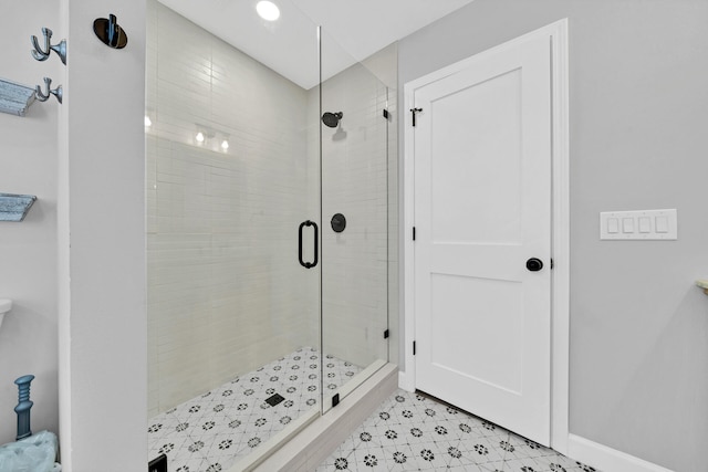 bathroom with tile floors and a shower with shower door