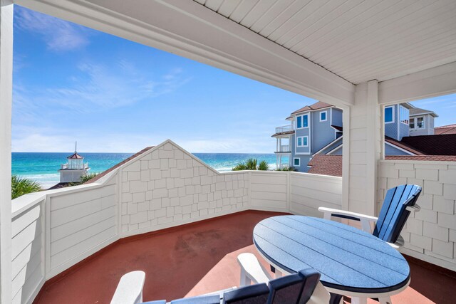 view of terrace featuring a balcony and a water view